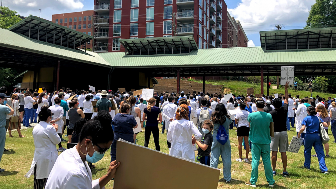 White coats for Black Lives event showing health workers in a park