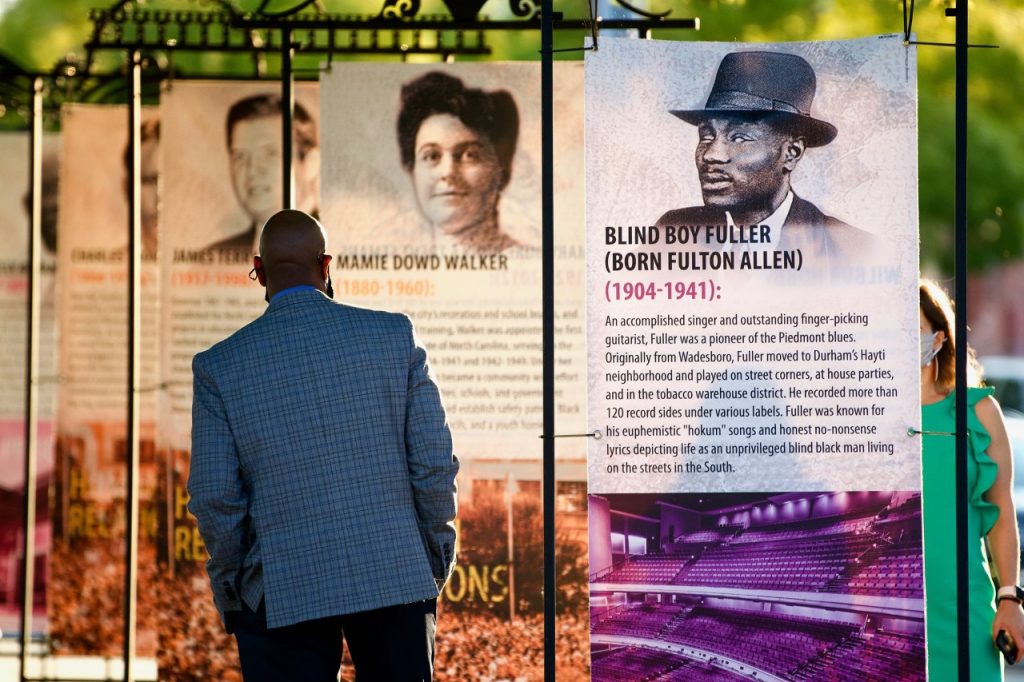 Photo of man viewing outdoor banner exhibits